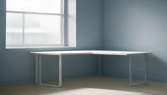 A bright, airy home office corner with an empty chair pushed back from a minimal desk beside a large window in cool blue-grey tones.